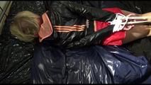 Pia tied and gagged on a bed wearing a sexy red adidas sprinter and a black/orange rain jacket (Video)