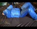 Jill putting on a sexy blue shiny nylon down suit and lolling on bed (Pics)