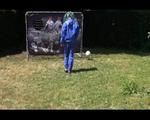 Mara wearing a blue rainwear combination while playing soccer with herself (Video)