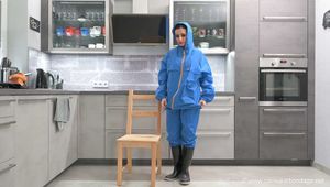 Miss Amira in Farmerrain raingear bound and gagged on a chair