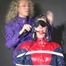 Watzching sexy PIA wearing a sexy oldschool rainwear combination in red/blue sitting on a hairdresser´s chair being tied and gagged from Sophie (Video)