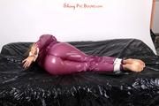 Sophie in an shiny transparent purple PVC suit tied and gagged in bed (Pics)