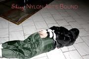 Jill tied, gagged and hooded on a cellar floor wearing a shiny green rain pants and a shiny black down jacket (Pics)