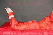 Destiny wearing a sexy red rain suit tied and gagged and hooded with ropes and a cloth gag on a bed (Pics)