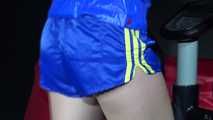 Sexy Sonja during her workout on the crosstrainer wearing a sexy blue/yellow shiny nylon shorts and a rain jacket (Video)