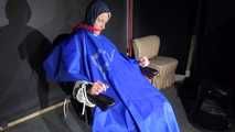 Watching Sonja sitting on a hairdresser`s chair wearing sexy blue shiny nylon rainwear with a raincape being tied, gagged and hooded with ropes and a clothgag (Video)