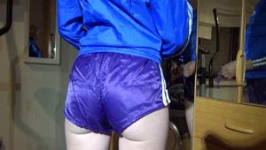 Sonja during her workout on the crosstrainer wearing a supersexy purple adidas shiny nylon shorts and a blue rain jacket (Video)