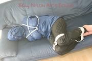 Katharina tied, gagged and hooded (breath control) on a sofa wearing sexy shiny nylon rainwear (Pics)