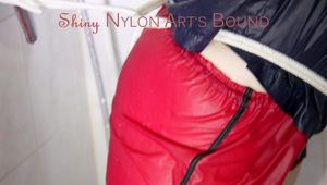 Jill tied and gagged on a shower with cuffs wearing a sexy red shiny nylon shorts and a black rain jacket (Pics)