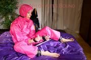 Pia ties and gagges herself on a bar in bed wearing a supersexy pink rainsuit (Pics)