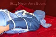 Lucy tied and gagged with a rope and a gag on a red sofa wearing an oldschool blue downwear combination (Pics)