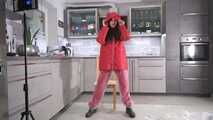 Miss Amira in red nylon rain gear and tranparent rain suit