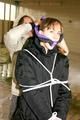 Blond-haired archive girl tied and gagged by another archive girl wearing shiny down jackets (Pics)