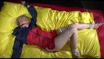 SEXY SONJA being tied and gagged on a bed stimulated with an massager wearing a hot red shiny nylon shorts and an oldschool red/blue rain jacket (Video)