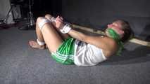 Sexy Sandra being tied and gagged on the floor wearing a sexy green shiny nylon shorts and a white top (Video)