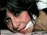 40 Yr OLD HAIRDRESSER CHER IS TIED FACE DOWN ON BED WITH KNEES TIED TOGETHER & NYLON COVERED FEET TIED 3 FEET APART TO HEADBOARD & IS CLEAVE GAGGED (D53-11)