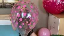 pink happy birthday balloons popping fun with fingernails and wooden stick