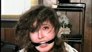ERICA IS MOUTH STUFFED, WRAP TAPE GAGGED & BALL-TIED (D29-8)