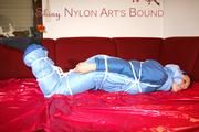 Lucy tied and gagged with a rope and a gag on a red sofa wearing an oldschool blue downwear combination (Pics)