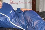 Pia wearing a sexy oldschool shiny nylon AGU rainwear combination posing and lolling on bed (Pics)