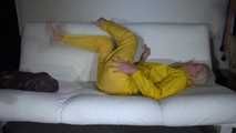 Watching Pia preparing her sofa with a shiny nylon cloth wearing a yellow shiny nylon rainsuit enjoying herslef on the sofa (Video)