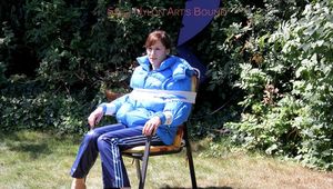 Julia tied and gagged in a shiny nylon downjacket