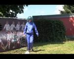 Mara wearing a blue rainwear combination while playing soccer with herself (Video)