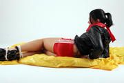 Jessy bound in red shorts and a shiny black jacket