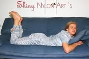 Katharina wearing a supersexy grey shiny nylon rainwear catsuit while lolling on the sofa (Pics)