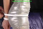 Alina bound with Leather-Belts and ballgagged in a shiny silver Dress