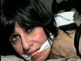 40 Yr OLD HAIRDRESSER CHER IS TIED FACE DOWN ON BED WITH KNEES TIED TOGETHER & NYLON COVERED FEET TIED 3 FEET APART TO HEADBOARD & IS CLEAVE GAGGED (D53-11)