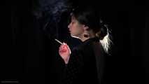Irina is smoking 100mm cigarette in the dark room
