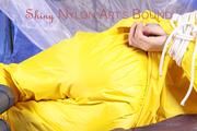 Alina tied, gagged and hooded on a princess bed in an old cellar wearing a shiny yellow rain combination (Pics)