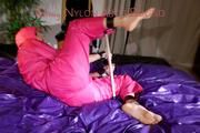 Pia ties and gagges herself on a bar in bed wearing a supersexy pink rainsuit (Pics)