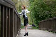 Miss Petra in a hot vinyl skirt, high heels and transparent blouse at photo shooting