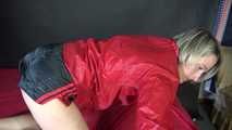 Watching sexy Sonja during preparing the bed wearing sexy black shiny nylon shorts and a red rain jacket (Video)