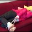 Mara tied and gagged on a sofa wearing a shiny pink down jacket and a black rain pants (Video)