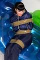 Jill tied and gagged in a shiny nylon down jacket 