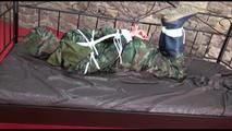 Pia tied, gagged and hooded in a princess bed wearing a sexy shiny camouflage rainwear (Video)