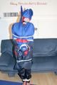 Jill tied, gagged and hooded wearing shiny nylon rainwear (Pics)