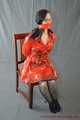 Bound in PVC minidress and red raincoat