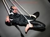 Archive girl tied, gagged and hung wearing a shiny black rainsuit (Pics)