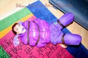 Jill tied and gagged with webbing load restraint assembly on the floor wearing a sexy purple down jacket and a rain pants (Pics)