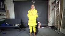 Ms Ungeniert tied, gagged and hooded in shiny nylon yellow Downjacket