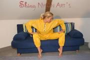 Sexy blonde archive girl posing and lolling on a sofa wearing sexy yellow rainwear over nothing (Pics)