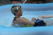 Sexy Sonja wearing a darkblue shiny nylon shorts and a yellow top enjoying the water in the swimming pool (Pics)