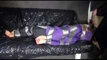 SANDRA tied and gagged with tape on a sofa wearing a sexy black shiny nylon pants and a purple rain jacket (Video)