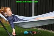 Watching sexy RONJA wearing a sexy oldscholl blue shiny nylon shorts and a rainjacket lolling in a hammock enjoying the sun (Video)