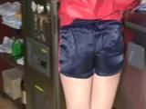 Jill in a bar wearing a sexy blue/red shiny nylon shorts and a red rain jacket (Video)