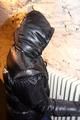 Jill tied and gagged in a black downjacket and rainpants